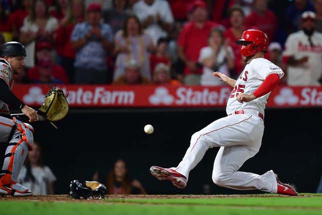 Aug 7, 2023; Anaheim, California, USA; Los Angeles Angels first baseman C.J. Cron scores a run against San Francisco Giants catcher Patrick Bailey (14) during the sixth inning at Angel Stadium.