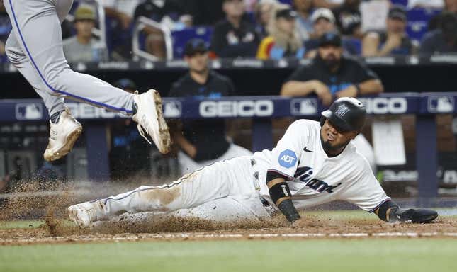 Jun 6, 2023; Miami, Florida, USA; Miami Marlins second baseman Luis Arraez (3) scores on a wild pitch against the Kansas City Royals during the seventh inning at loanDepot Park.