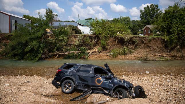 A vehicle destroyed by flooding sits in Trace Creek on Aug. 23, 2021 in Waverly, Tennessee