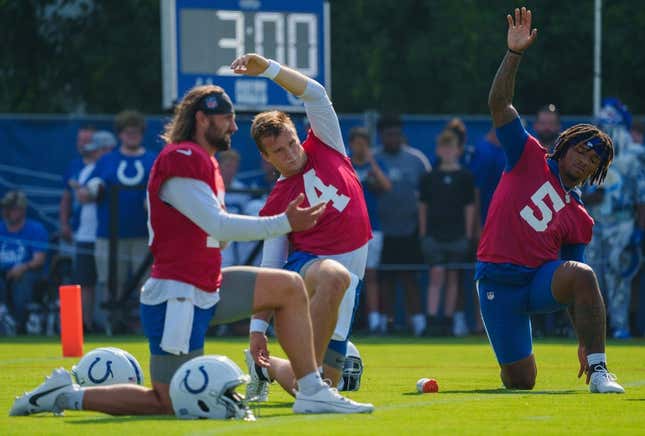 Indianapolis Colts quarterbacks Gardner Minshew (10), Sam Ehlinger (4), and Anthony Richardson (5) stretch before the first day of training camp practice Wednesday, July 26, 2023, at Grand Park Sports Complex in Westfield, Indiana.