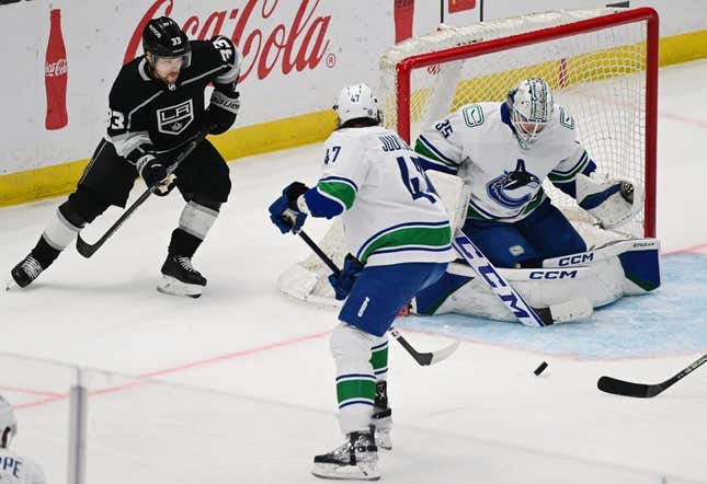 Mar 18, 2023; Los Angeles, California, USA;  Vancouver Canucks goaltender Thatcher Demko (35) makes a save as Los Angeles Kings right wing Viktor Arvidsson (33) looks for the puck in a NHL game at Crypto.com Arena.