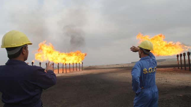Iraqi Southern Oil Company engineers look towards the gas flares in the Zubair oil field in southern Iraq.