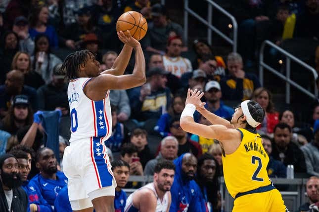 Mar 18, 2023; Indianapolis, Indiana, USA; Philadelphia 76ers guard Tyrese Maxey (0) shoots the ball while  Indiana Pacers guard Andrew Nembhard (2) defends in the second quarter at Gainbridge Fieldhouse.