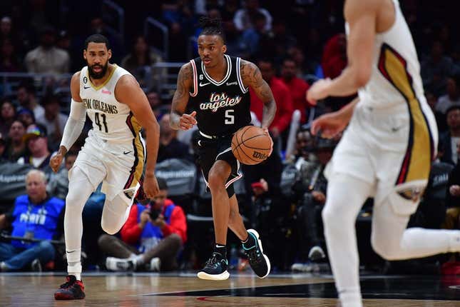 Mar 25, 2023; Los Angeles, California, USA; Los Angeles Clippers guard Bones Hyland (5) moves the ball ahead of New Orleans Pelicans forward Garrett Temple (41) during the second half at Crypto.com Arena.