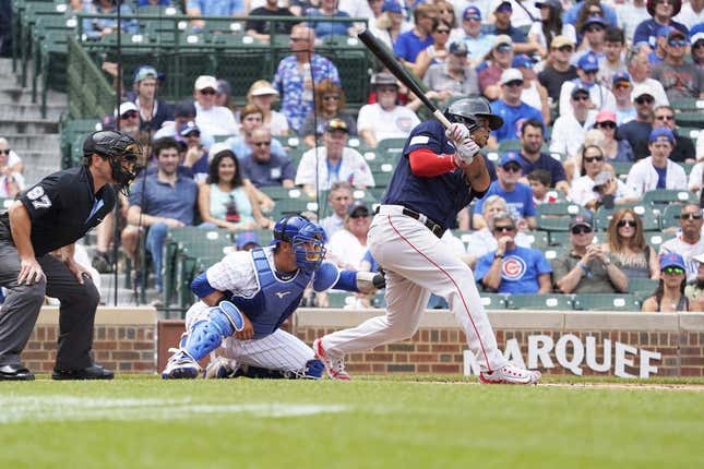 Jul 16, 2023; Chicago, Illinois, USA; Boston Red Sox third baseman Rafael Devers (11) hits a home run against the Chicago Cubs during the first inning at Wrigley Field.