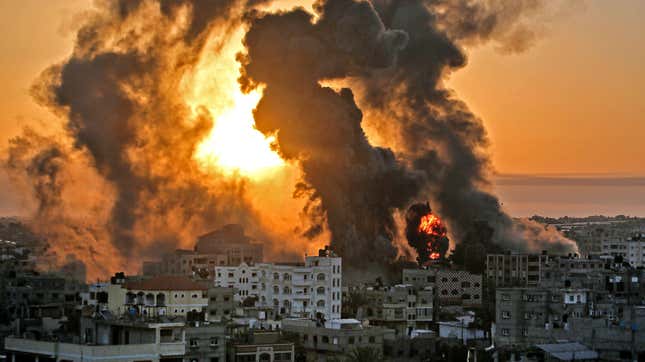 A fire rages at sunrise in Khan Yunish following an Israeli airstrike on targets in the southern Gaza strip, early on May 12, 2021.