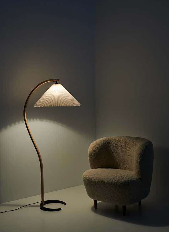 The Timberline Floor Lamp and a bouclé chair.