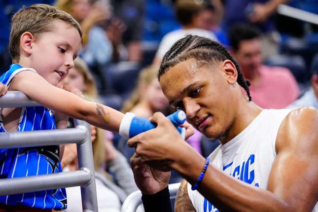 Apr 02, 2023; Orlando, FL, USA; Orlando Magic forward Paolo Banchero (5) signs autographs with fans before the game against the Detroit Pistons at the Amway Center.