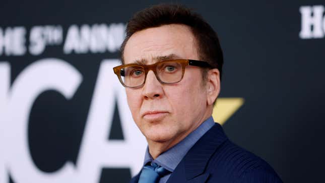 Nicolas Cage wears a blue suit and brown eyeglasses at a recent red-carpet event.