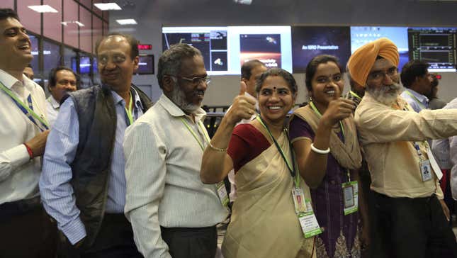 Indian Space Research Organisation scientists and officials cheer as they celebrate the success of Mars Orbiter Mission.