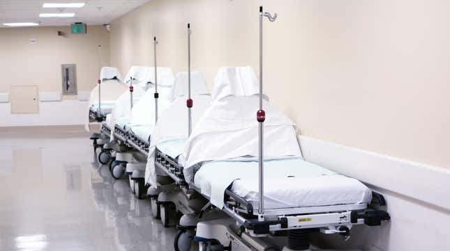 Empty hospital beds in a row