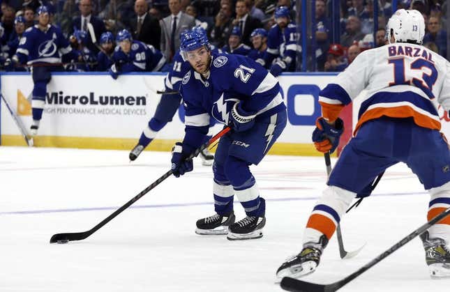 Oct 22, 2022; Tampa, Florida, USA; Tampa Bay Lightning center Brayden Point (21) passes the puck against the New York Islanders during the third period at Amalie Arena.