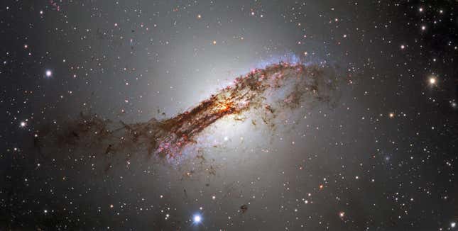 Bands of dust obscure Centaurus A, a distant galaxy.