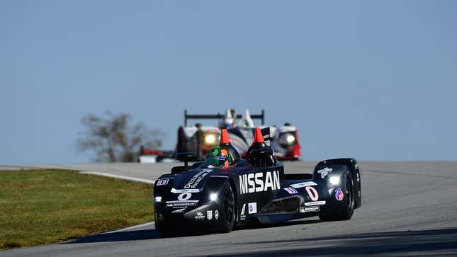 A photo of the black Nissan DeltaWing race car on track. 