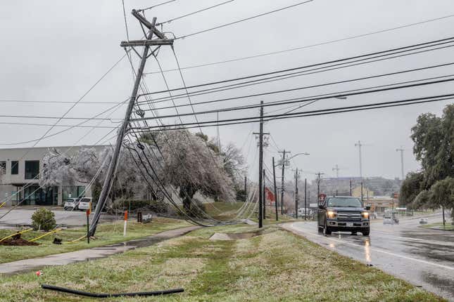 Frozen power lines are seen hanging near a sidewalk on February 01, 2023 in Austin, Texas. A winter storm is sweeping across portions of Texas, causing massive power outages and disruptions of highways and roads. 