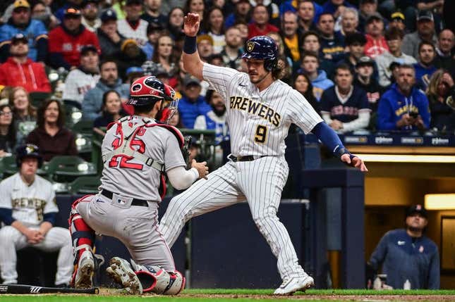 Apr 22, 2023; Milwaukee, Wisconsin, USA; Milwaukee Brewers third baseman Brian Anderson (9) is tagged out by Boston Red Sox catcher Connor Wong (12) while trying to score in the second inning at American Family Field.