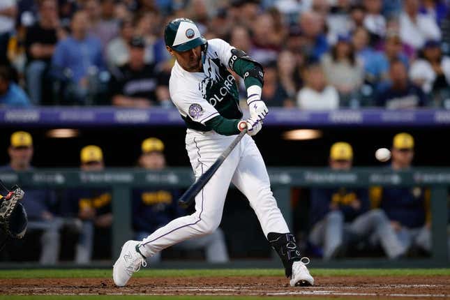 May 3, 2023; Denver, Colorado, USA; Colorado Rockies second baseman Alan Trejo (13) hits a three RBI double in the fourth inning against the Milwaukee Brewers at Coors Field.