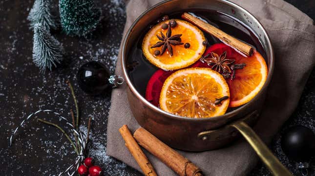 Mulled wine in a saucepan with spices and oranges