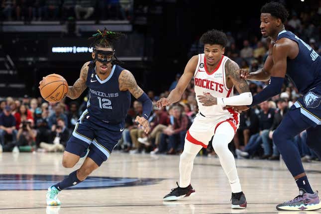 Mar 22, 2023; Memphis, Tennessee, USA; Memphis Grizzlies guard Ja Morant (12) drives to the basket as Houston Rockets guard Jalen Green (4) defends during the second half at FedExForum.