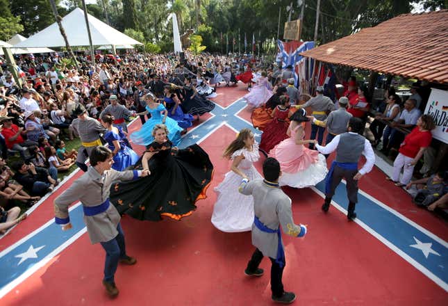 Descendants of American Southerners wearing Confederate-era dresses and uniforms dance during a party in Santa Barbara D'Oeste, Brazil