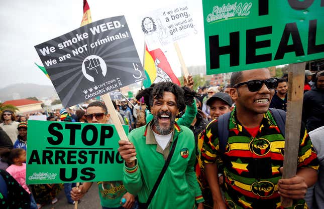 Demonstrators hold placards during a 2017 march calling for the legalization of cannabis in South Africa.