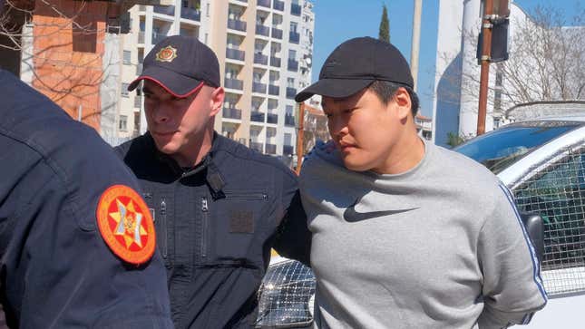Montenegrin police officers escort an individual who is believed to be one of the most wanted fugitives, South Korean citizen, Terraform Labs founder Do Kwon in Montenegro's capital Podgorica, Friday, March 24, 2023