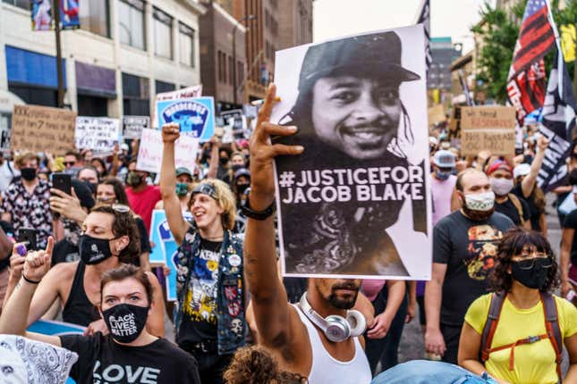 Protesters march near the Minneapolis 1st Police precinct during a demonstration against police brutality and racism on August 24, 2020 in Minneapolis, Minnesota.