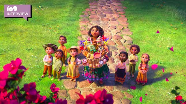 Encanto's animated Mirabel and a number of children on a stone walkway look up in wonder at the Madrigals' house, which is bathed in flowers.