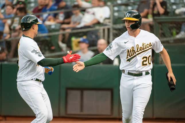 Aug 22, 2023; Oakland, California, USA; Oakland Athletics second baseman Zack Gelof (20) celebrates with shortstop Aledmys Diaz (12) after scoring during the first inning against the Kansas City Royals at Oakland-Alameda County Coliseum.