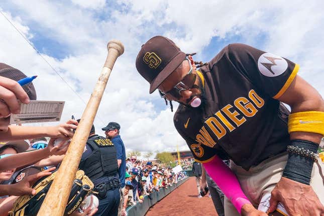 Mar 16, 2023; Salt River Pima-Maricopa, Arizona, USA; San Diego Padres outfielder Fernando Tatis Jr. (23) blows a bubblegum bubble as he signs autographs for fans before the start of the first inning for a spring training game against the Colorado Rockies at Salt River Fields at Talking Stick.