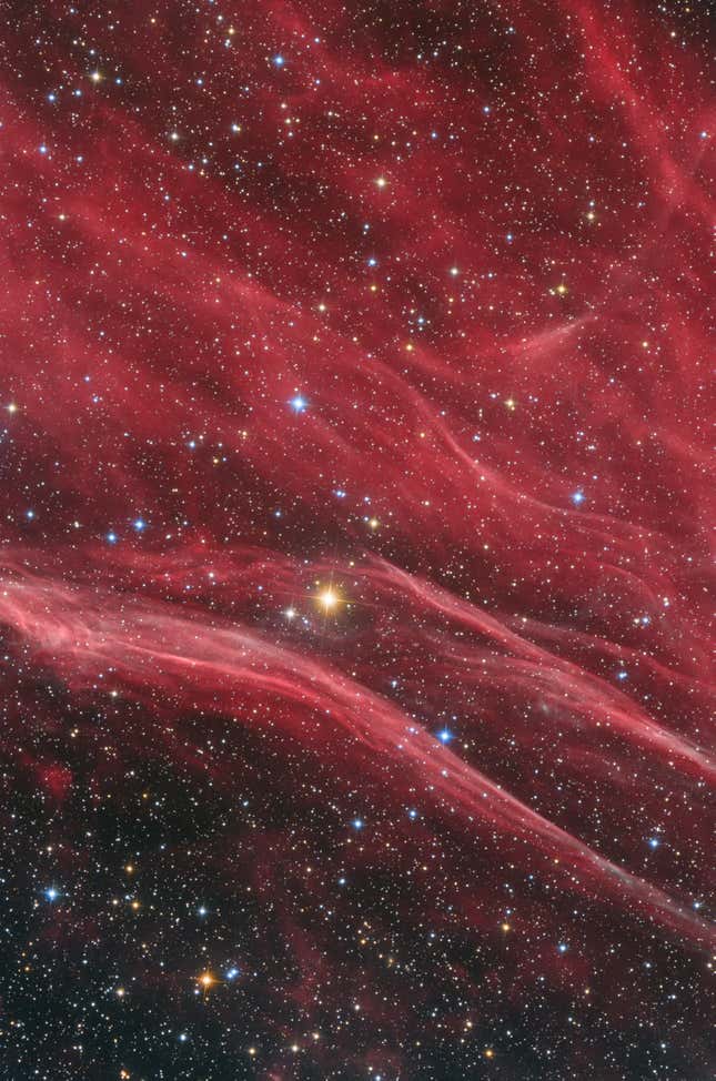 The wispy reds of a supernova remnant.