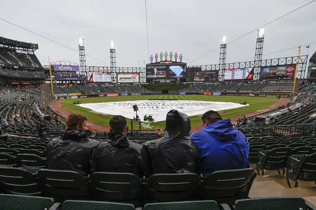 Jun 25, 2022; Chicago, Illinois, USA; Fans wait for a start of a baseball game between the Baltimore Orioles and the Chicago White Sox as tarp covers the infield during a rain delay at Guaranteed Rate Field.
