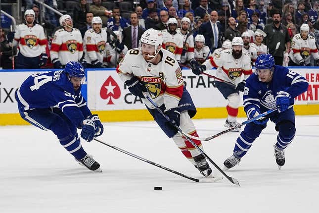 May 4, 2023; Toronto, Ontario, CANADA; Florida Panthers forward Matthew Tkachuk (19) carries the puck past Toronto Maple Leafs defenseman Morgan Rielly (44) and  forward Mitchell Marner (16) during the second period of game two of the second round of the 2023 Stanley Cup Playoffs at Scotiabank Arena.