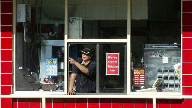 Drive thru worker points out of window