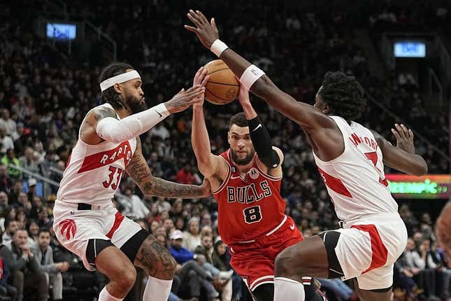 Feb 28, 2023; Toronto, Ontario, CAN; Chicago Bulls guard Zach LaVine (8) tries to get past Toronto Raptors guard Gary Trent Jr. (33) and forward O.G. Anunoby (3) during the second half at Scotiabank Arena.