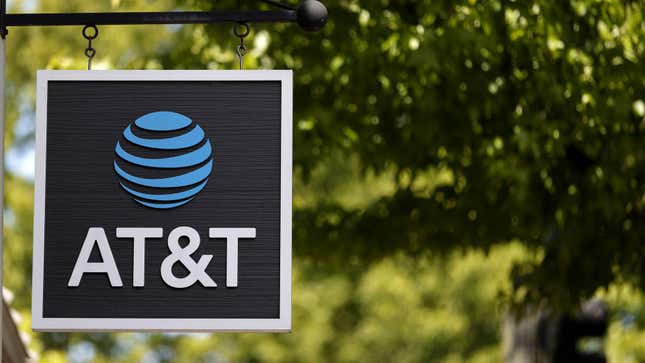 AT&T sign hangs from a pole.