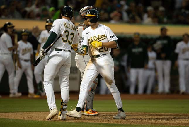 Jul 22, 2023; Oakland, California, USA; Oakland Athletics second baseman Zack Gelof (20) gets a congratulatory handshake from JJ Bleday (33) after hitting his first career home run during the seventh inning against the Houston Astros at Oakland-Alameda County Coliseum.