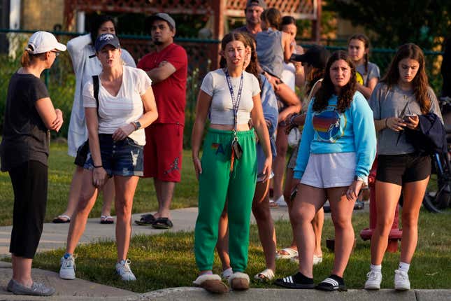 Bystanders near the scene of the July 4th shooting in Highland Park, Illinois.