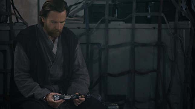 Obi-Wan Kenobi looks at his saber.