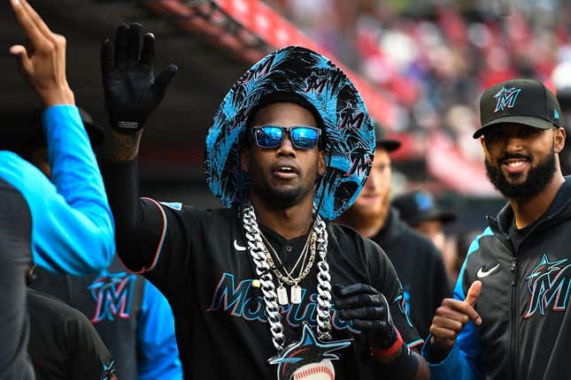 Miami Marlins' Jorge Soler holds a plaque in honor of Robert