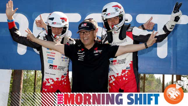 Ott Tanak, right, and Martin Jarveoja, left, celebrate their victory with Toyota President Akio Toyoda after day four of the 2018 WRC Rally Finland.
