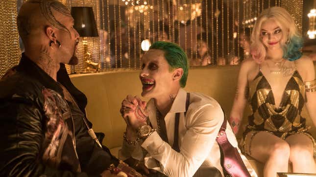 Jared Leto as the Joker and Margot Robbie as Harley Quinn plotting with Common as Monster T in Suicide Squad