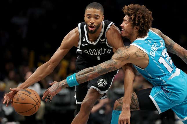 Mar 5, 2023; Brooklyn, New York, USA; Brooklyn Nets forward Mikal Bridges (1) drives to the basket against Charlotte Hornets guard Kelly Oubre Jr. (12) during the fourth quarter at Barclays Center.