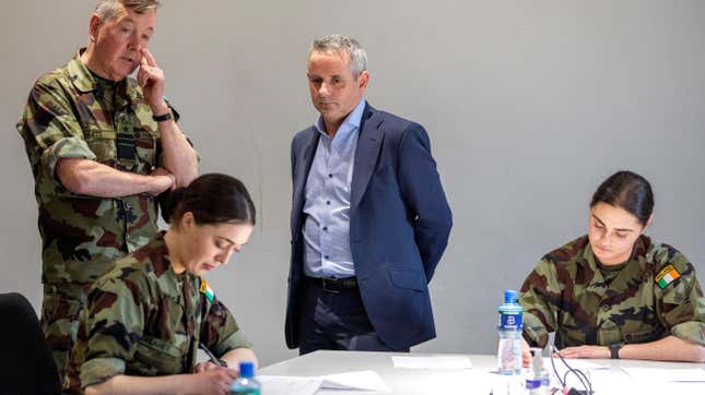 File photo of the CEO of Ireland’s Health Service Executive (HSE) Paul Reid (center) and Chief of Staff of Ireland’s Defense Forces, Vice Admiral Mark Mellett (left) with Irish Army cadets on March 13, 2020.