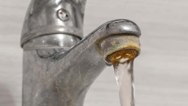 Faucet with running water and hard water build-up