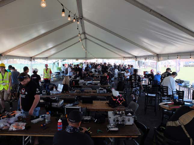 Racers and their teams preparing their drones.