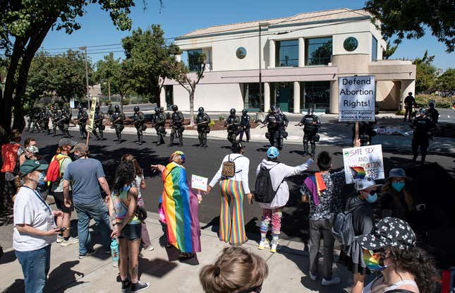 Police in tactical gear confront straight pride protesters and counter-protesters who clashed outside a Planned Parenthood clinic in Modesto.