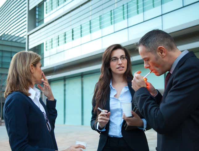 Image for article titled Group Of People All Smoking Cigarettes Outside Building Must Have Just Finished Sex Together