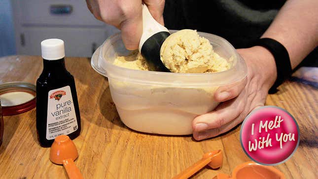 Hand scooping homemade vanilla ice cream out of a tub