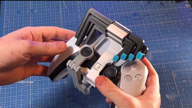 Akaki Kuumeri showcases the directional pad attachment to his PS5 controller mod, which migrates the buttons so they are above the face buttons.